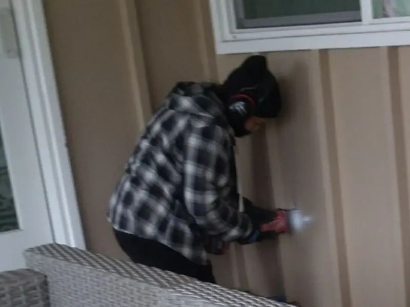 Professional electrician installing an exterior outlet in Tri-City
